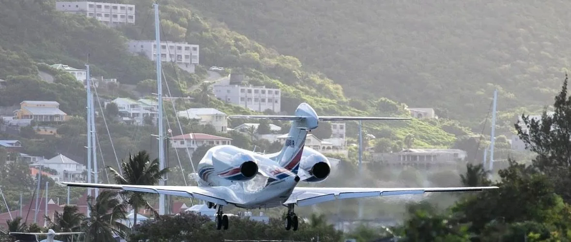 Cessna Citation X arriving over a Caribbean hillside, private jet charter services