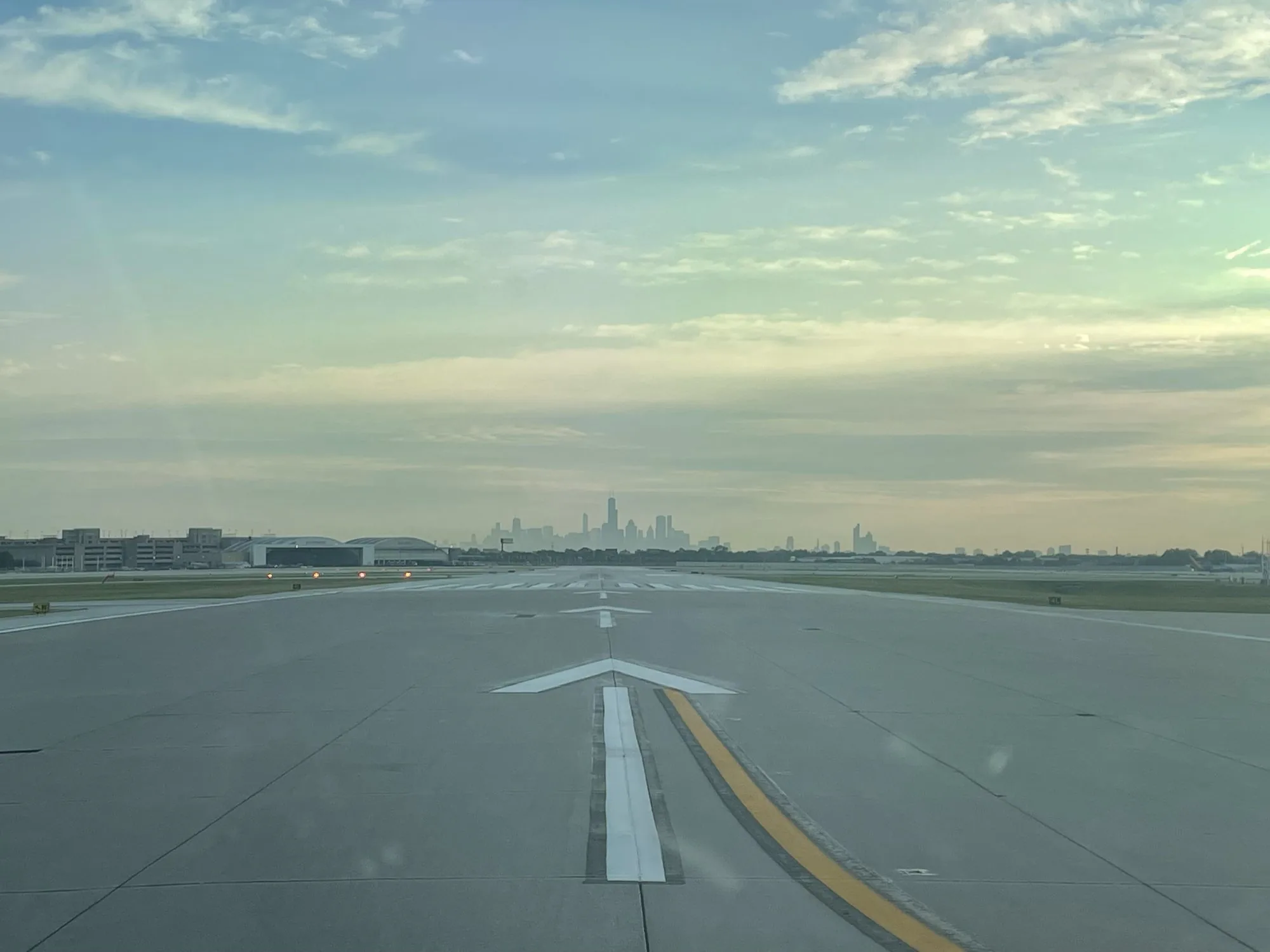 Business jet on the taxiway with city skyline in the background, private jet charter network
